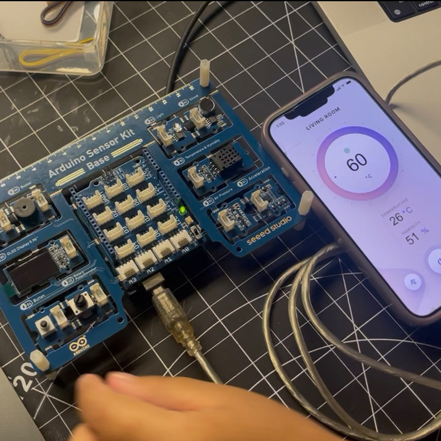 This photo shows the arduino hooked up to the computer by USB, the protopie app with the thermostat prototype is active.